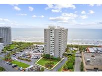 Condo complex featuring beachfront access, ample parking, swimming pool, and meticulously maintained landscaping at 9820 Queensway Blvd. # 105, Myrtle Beach, SC 29572