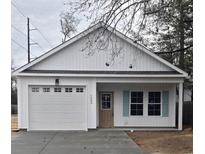 Charming one-story home with white siding and a two-car garage at 1003 28Th Ave. S, North Myrtle Beach, SC 29582