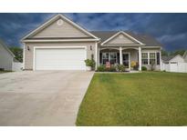 Gray house with white garage door, landscaped lawn, and front porch at 141 Baylee Circle, Galivants Ferry, SC 29544