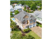 Aerial view of a two-story home with a well-manicured lawn, two-car garage, and a private backyard pool at 352 Sea Marsh Rd., Murrells Inlet, SC 29576