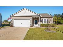One-story house with attached garage, landscaping, and a spacious driveway at 3716 Mackevans Ct., Myrtle Beach, SC 29579