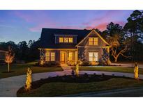 Stunning two-story home with a charming front porch and landscaped yard at 4048 Girvan Dr., Myrtle Beach, SC 29579