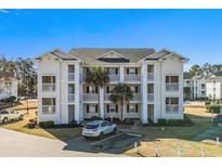 Two-story condo building with balconies, palm trees, and ample parking at 448 Red River Ct. # 39H, Myrtle Beach, SC 29579