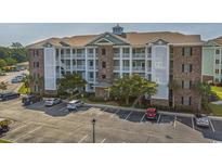 Exterior of a three-story building with parking in front at 4855 Luster Leaf Circle # 302, Myrtle Beach, SC 29577