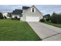Two-story house with gray siding, a two-car garage, and a well-maintained lawn at 6104 Quinn Rd., Myrtle Beach, SC 29579
