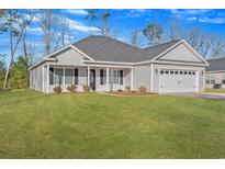 Newly constructed house with a two-car garage and a spacious lawn at 949 9Th Ave., Galivants Ferry, SC 29544