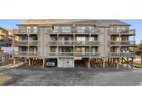 Three-story building with multiple balconies and parking underneath at 9621 Shore Dr. # B-112, Myrtle Beach, SC 29572