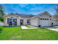 Charming one-story home featuring a well-manicured lawn, neutral siding, and attached garage at 9650 Bradford Ln., Murrells Inlet, SC 29576