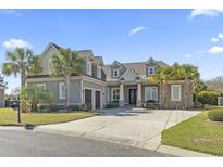 Beautiful two-story home featuring a three-car garage, well-manicured lawn, and a spacious driveway at 1422 Bohicket Ct., Myrtle Beach, SC 29579