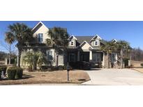 Two-story house with palm trees and a gray exterior at 1422 Bohicket Ct., Myrtle Beach, SC 29579