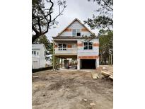 Under construction two-story home with a drive-under garage and framed balcony at 1718 26Th Ave. N, North Myrtle Beach, SC 29582