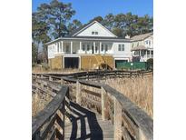 Exterior view of the home showcasing the surrounding landscape and elevated structure at 214 Olde Harbour Ct, Little River, SC 29566