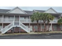 Attractive two-story building with stairs and palm trees at 241 Presidential Dr., Surfside Beach, SC 29575