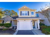 Two-story townhome with attached garage and landscaping at 2450 Marsh Glen Dr. # 821, North Myrtle Beach, SC 29582