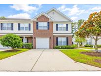 Brick front two-story townhome with attached garage and landscaping at 257 Connemara Dr. # E, Myrtle Beach, SC 29579
