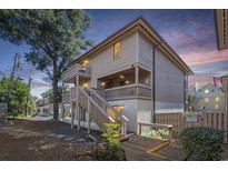 Multi-level home featuring balconies, wood siding, and a wooden staircase leading to the entrance at 306 74Th Ave. N # 208, Myrtle Beach, SC 29572