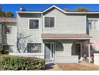 Exterior of charming light green townhouse with a small front yard at 38 Shadow Moss Pl. # 38, North Myrtle Beach, SC 29582