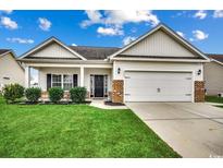Charming one-story house with a brick facade, two-car garage, and well-maintained lawn at 4060 Woodcliffe Dr., Conway, SC 29526