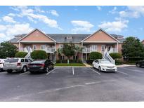 Exterior view of a charming three-unit building with ample parking at 4759 Lightkeepers Way # 14A, Little River, SC 29566