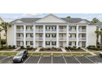 Three-story building exterior with parking and landscaping at 5060 Windsor Green Way # 203, Myrtle Beach, SC 29579