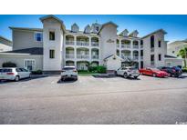 Three-story building exterior with parking and landscaping at 1017 World Tour Blvd. # 201, Myrtle Beach, SC 29579