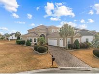 Two-story house with a three-car garage and landscaped lawn at 1122 Bluffton Ct., Myrtle Beach, SC 29579