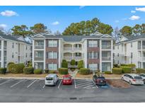Brick building exterior with parking and landscaping at 1310 River Oaks Dr. # 2I, Myrtle Beach, SC 29579