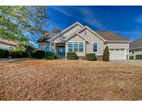 Charming single-story home features neutral siding, stone accents, manicured landscaping, and an attached two-car garage at 1405 Surf Pointe Dr., North Myrtle Beach, SC 29582