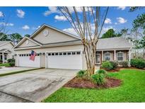 Attractive exterior with two-car garage and well-manicured lawn at 203 Knight Circle # 2, Pawleys Island, SC 29585