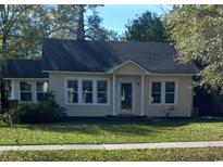 Charming yellow house with a well-maintained lawn and gray roof at 326 East Godbold St., Marion, SC 29571