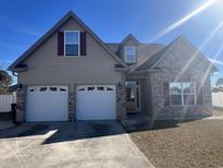Charming two-story home with brick accents, a two-car garage, and well-maintained landscaping in a desirable community at 389 Cabo Loop, Myrtle Beach, SC 29588
