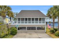 Two-story beach home with covered porch and parking area at 404 29Th Ave. N, North Myrtle Beach, SC 29582