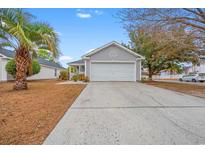 Gray house with white garage door and landscaping at 4600 Hidden Creek Ln., Myrtle Beach, SC 29579