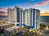 Aerial view of oceanfront resort; two towers, parking lot, and beach at 504 N Ocean Blvd. # 1511, Myrtle Beach, SC 29577