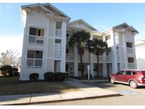 Two-story condo building with balconies and palm trees at 573 Blue River Ct. # 8-H, Myrtle Beach, SC 29579