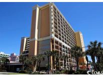 Oceanfront high-rise building with balconies and palm trees at 6900 N Ocean Blvd. # 111, Myrtle Beach, SC 29572
