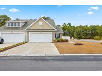Tan two-story home with attached garage and landscaping at 763 Eastridge Dr., Conway, SC 29526