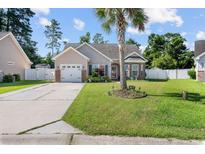 Charming single-story home with a well-maintained lawn, beautiful landscaping, and a welcoming driveway at 160 Maggie Way, Myrtle Beach, SC 29588