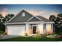 Two-story craftsman style home with a two-car garage and brick accents at 265 Hawks Run Dr., Calabash, NC 28467