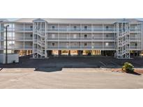 Spacious condo complex featuring balconies and white staircases for easy beach access at 310 Marsh Pl. # 108, Garden City Beach, SC 29576