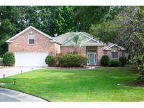 Brick house with a white garage door and lush green lawn at 3562 Battery Way Ct., Myrtle Beach, SC 29579