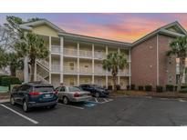 Two-story building exterior with parking and landscaping at 4271 Hibiscus Dr. # 201, Little River, SC 29566