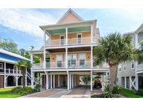 Two-story beach home with multiple balconies and a charming front porch at 504 21St Ave. N, North Myrtle Beach, SC 29582