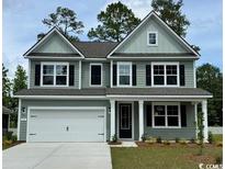 Charming two-story home with a well-maintained lawn and a classic architectural design at 515 Slaty Dr., Myrtle Beach, SC 29588