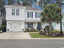 Two-story Craftsman home with a neutral exterior and landscaped front yard at 5220 Sea Coral Way, North Myrtle Beach, SC 29582