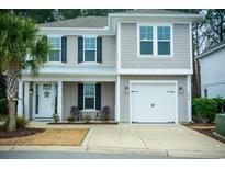 Two-story house with gray siding, white trim, and a two-car garage at 5224 Sea Coral Way, North Myrtle Beach, SC 29582