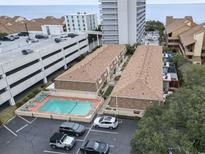 Overhead view of condo buildings, parking, and pool near the beach; some units have private patios at 5508 Porcher Dr. # 4, Myrtle Beach, SC 29577