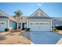 Charming light teal exterior boasts a two-car garage and manicured lawn at 6070 Tramonto St., Myrtle Beach, SC 29577
