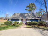 Ranch style home with gray roof and white front door at 804 47Th Ave. N, Myrtle Beach, SC 29577