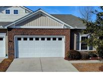 Attached home featuring a white garage door with a brick and siding exterior at 900 British Ln. # 1187, Myrtle Beach, SC 29579